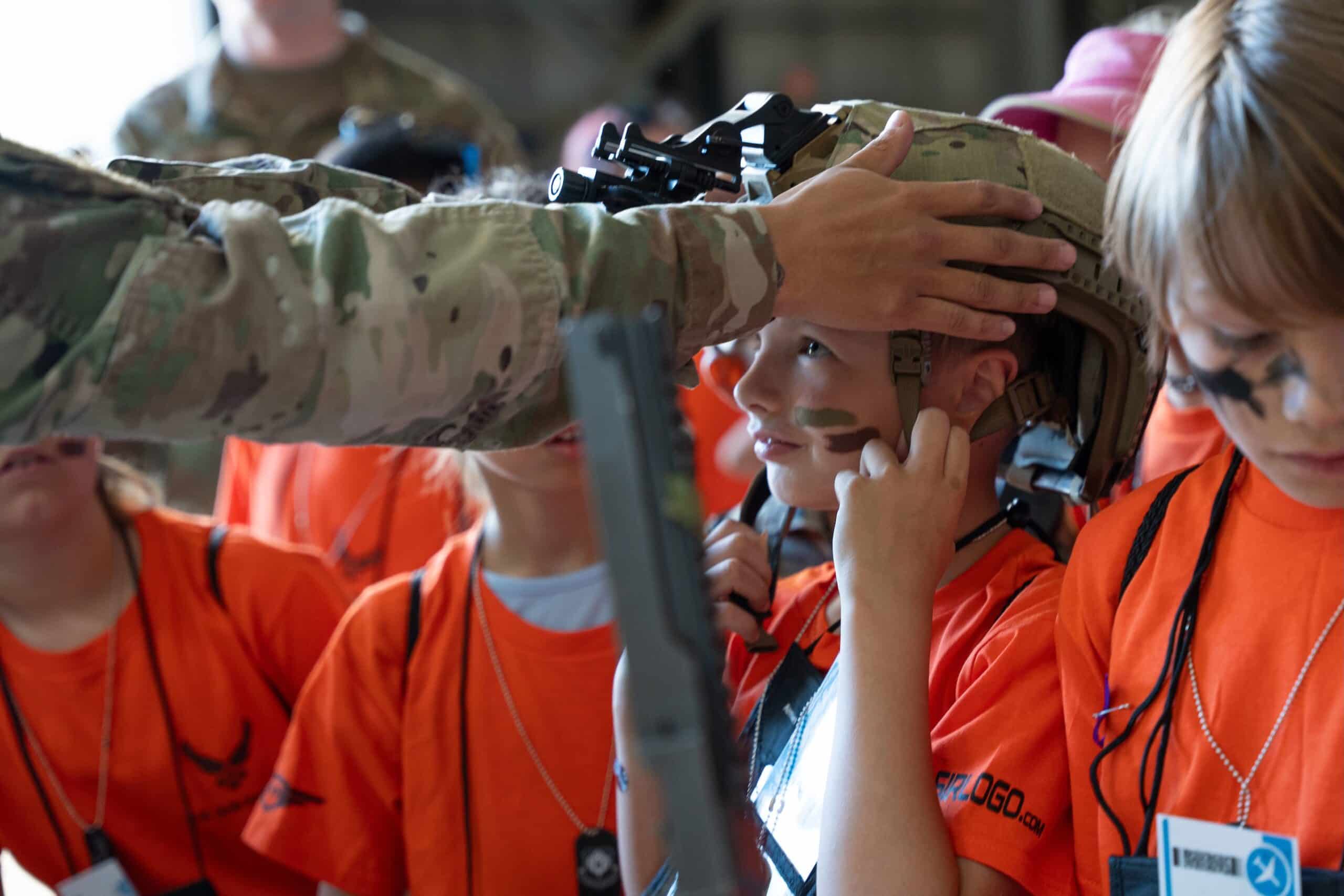 ACEs in the Community while a child tries on a helmet during Operation Kids